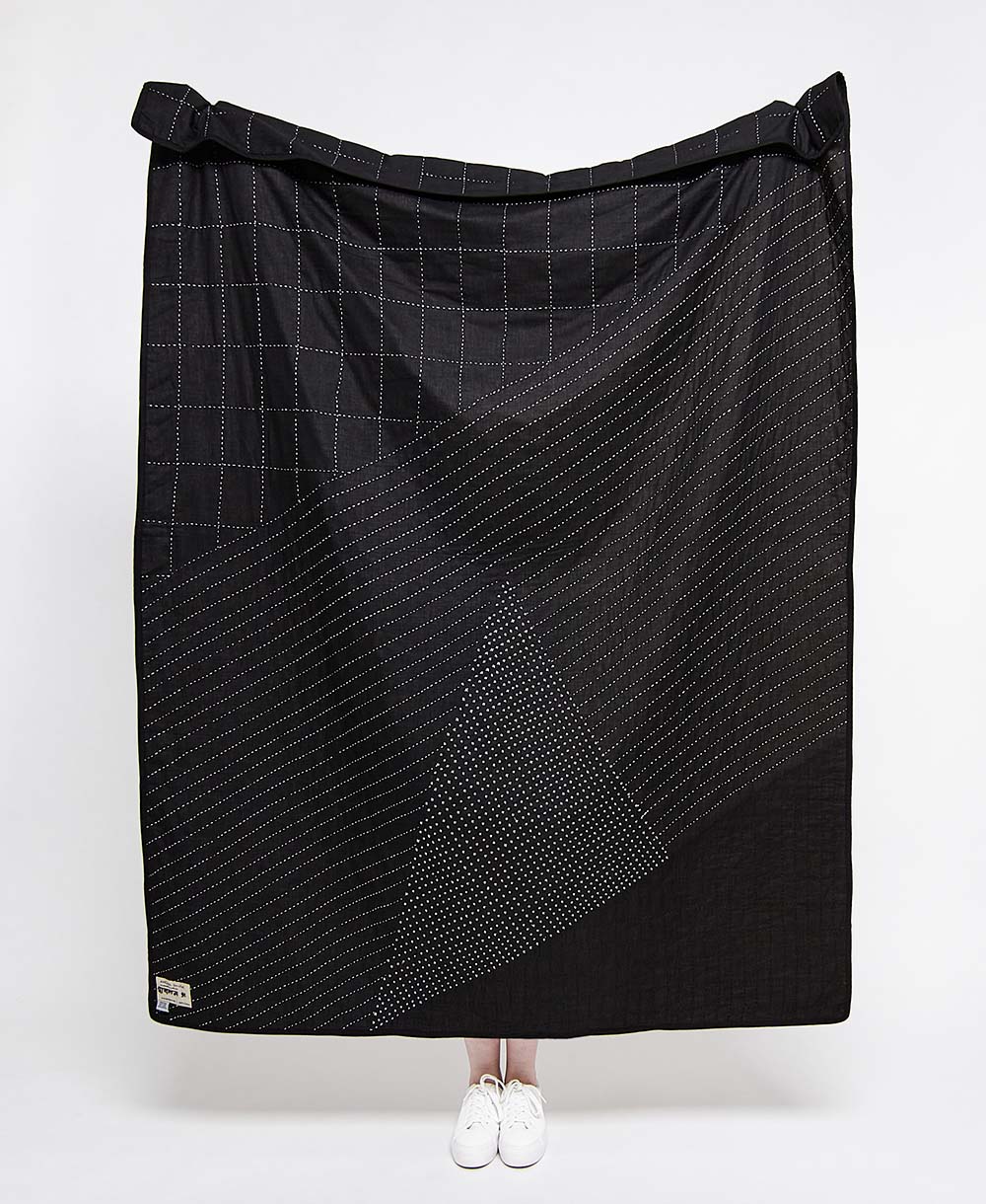 solid black quilted throw with white modern kantha embroidery in abstract stitch patterns