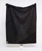 solid black quilted throw with white modern kantha embroidery in abstract stitch patterns