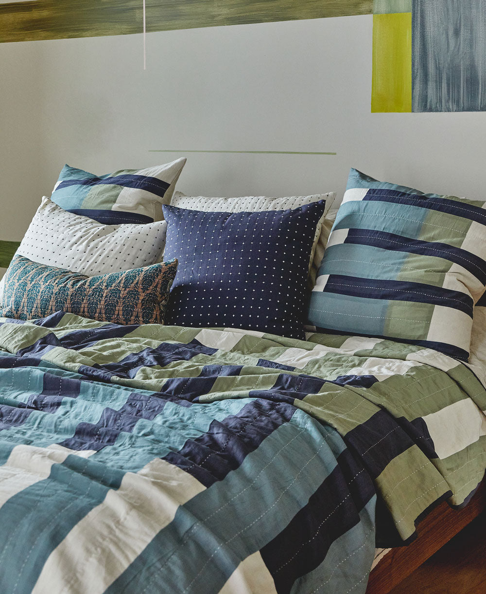 modern patchwork quilt with blue and green stripes made from 100% organic cotton