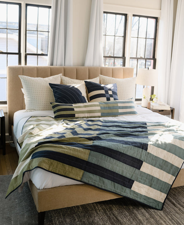 handmade modern striped kantha quilt on neutral bedding