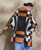 modern cocoon quilted jacket in bold patchwork plaid pattern with striking white embroidery