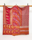 orange and red queen kantha quilt in a graphic paisley pattern handmade in India