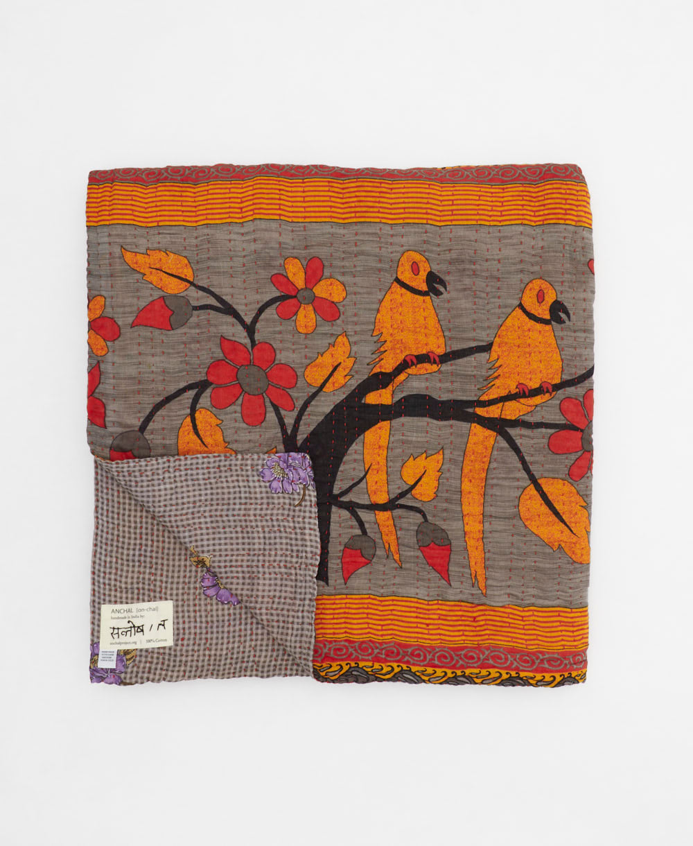 ethically made queen kantha quilt in purple-grey with an orange bird pattern and lavender florals made by Anchal artisans