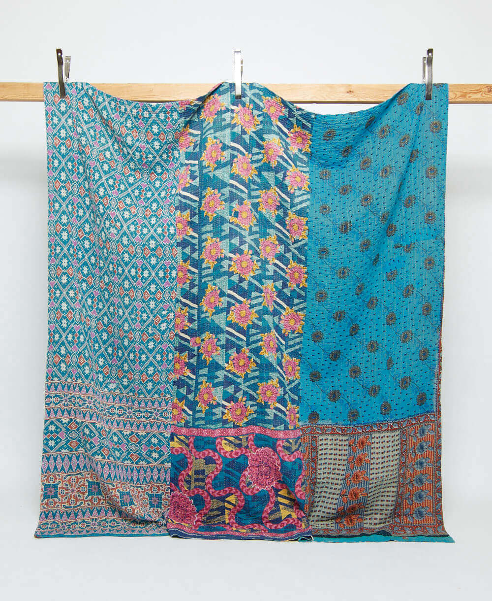 olympic blue queen kantha quilt with a pink geometric floral print handmade in India