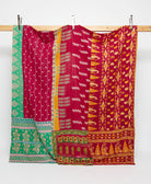 red and marigold queen kantha quilt with green accents handmade in India from vintage cotton saris