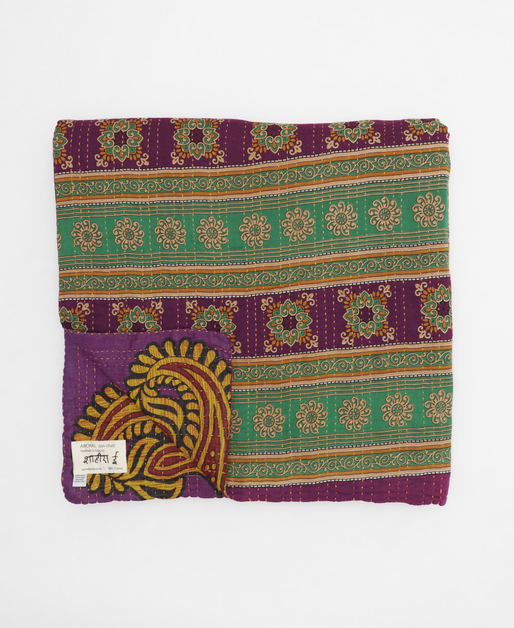 ethically made queen kantha quilt in plum purple with a bold golden yellow paisley pattern made by Anchal artisans