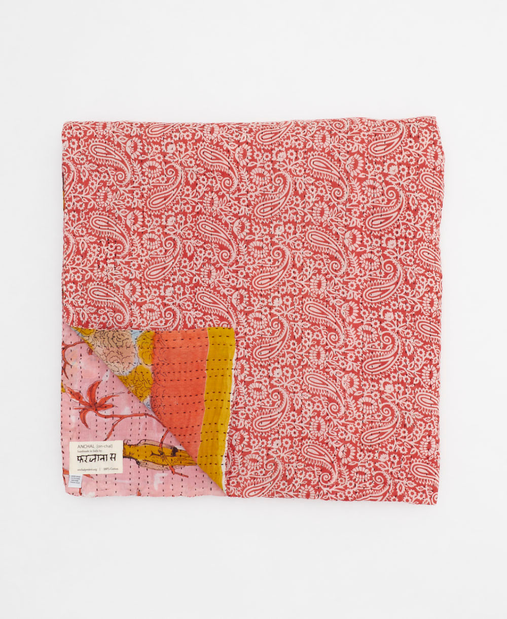 ethically made queen kantha quilt in coral with a bold golden yellow bird pattern made by Anchal artisans