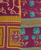 artisan-made kantha quilt in magenta-purple and cerulean blue floral design made from upcycled vintage cotton saris