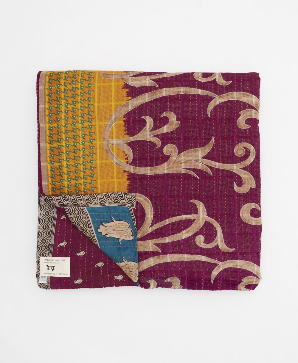 ethically made queen kantha quilt in magenta-purple with a bold cerulean blue flower design made by Anchal artisans