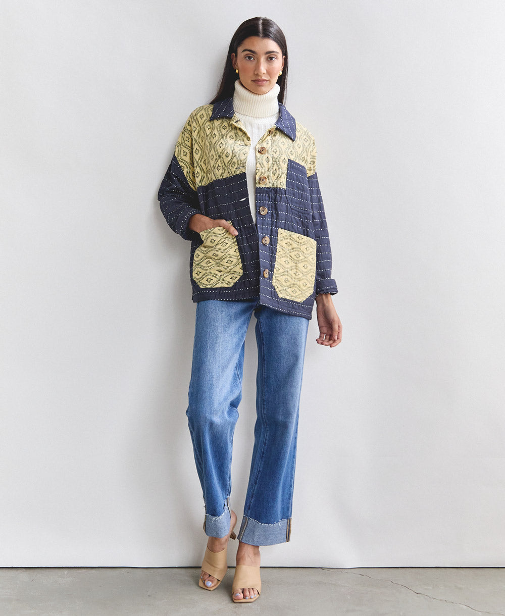 navy blue quilted chore jacket with vintage patchwork panels styled with cuffed straight jeans