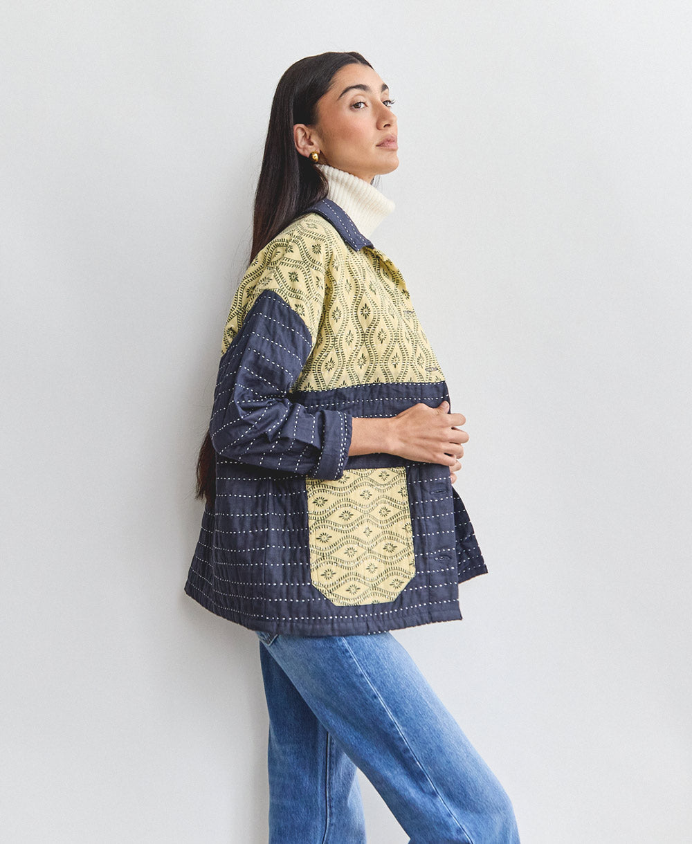 quilted chore jacket in navy blue with yellow vintage patchwork paneling and hand-quilted embroidery styled with vintage jeans