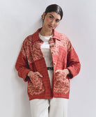 woman wearing all white with rust quilted chore jacket with vintage paisley patchwork handmade in India