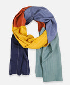 long scarf in colorful rainbow colors made from 100% organic cotton and finishing with hand embroidery