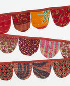 Decorative fabric banner with colorful patterns on a white background