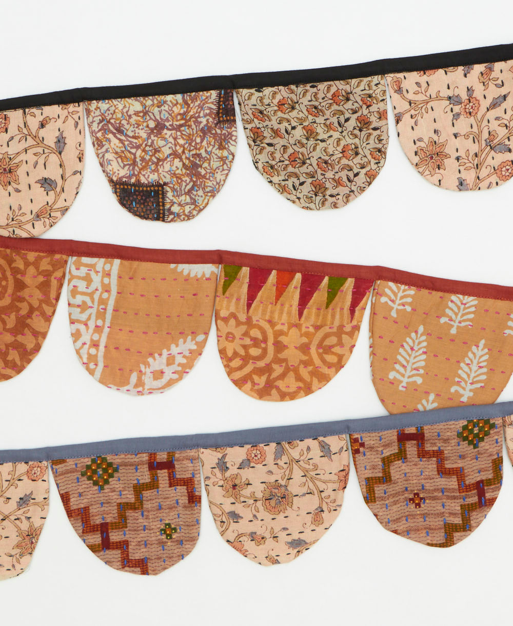 Decorative fabric bunting with intricate patterns on a white background