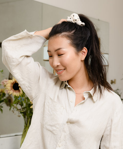 woman wearing a high ponytail in bone white organic cotton scrunchie