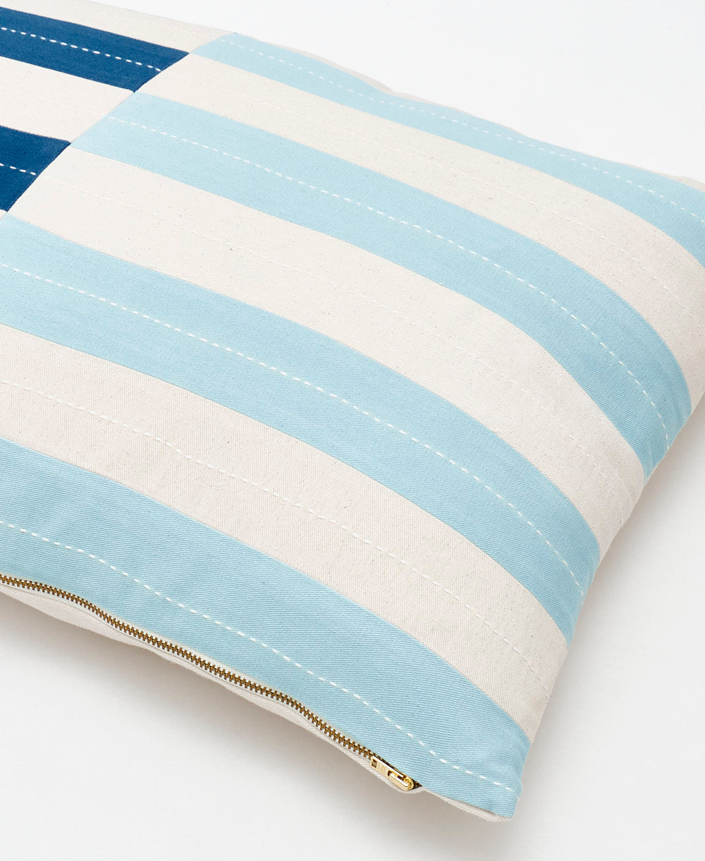 close up of shift lumbar pillow with a brass toned metal zipper closure