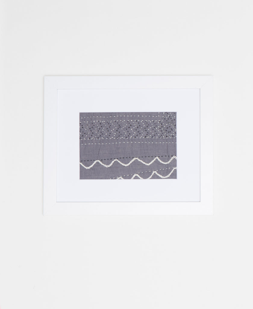 Handcrafted artisan-made framed textile art featuring a muted grey and white abstract design 