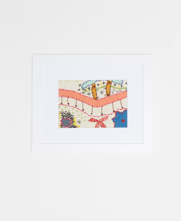 Handcrafted artisan-made framed textile artwork featuring a pastel and white color palette 