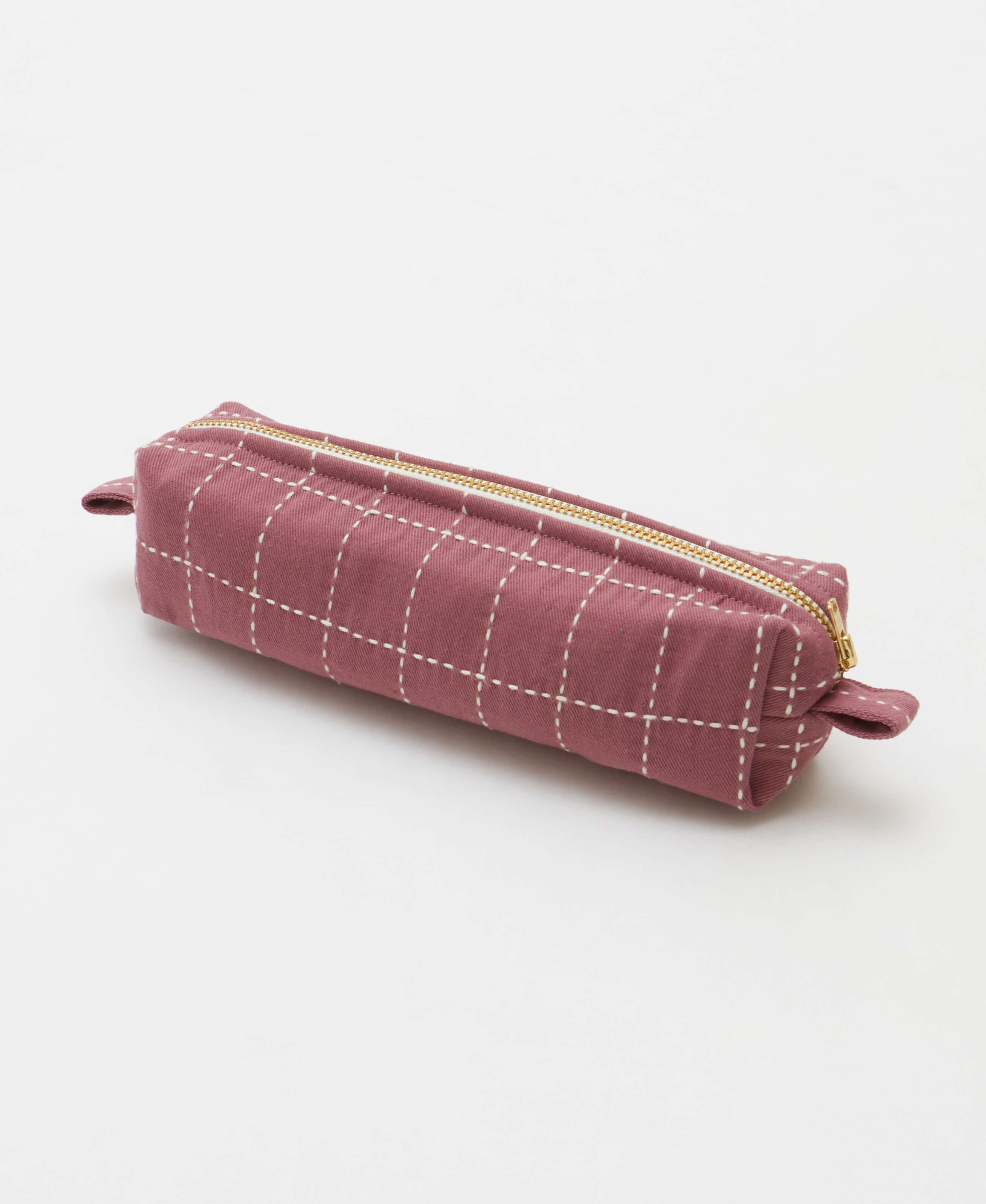 A mauve purple canvas pencil case with a white grid pattern and gold zipper, shown on a clean white background.