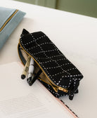 small zippered black pouch with grid-stitching design