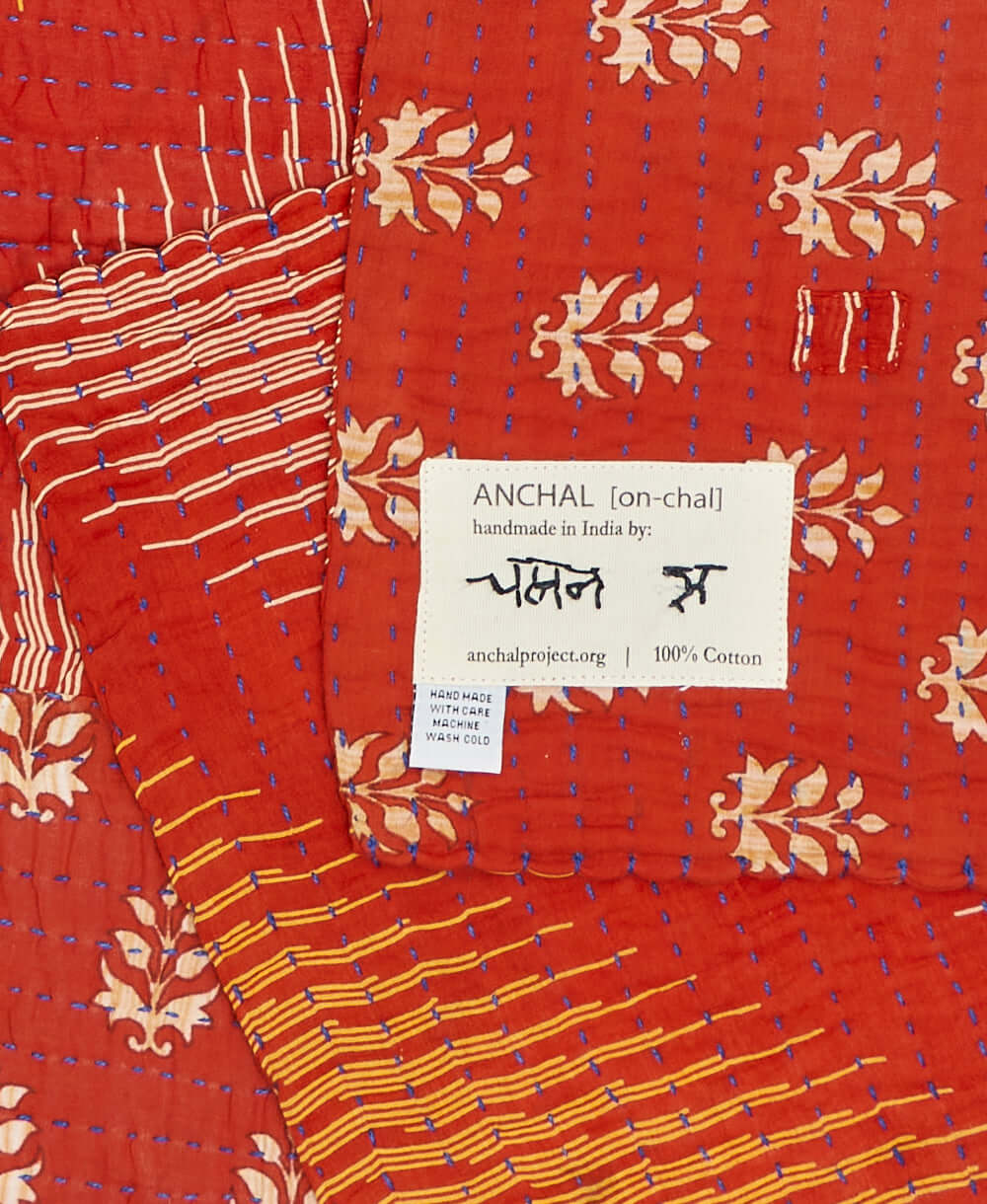 Hand stitched signature of the Artisan that created this red small kantha blanket