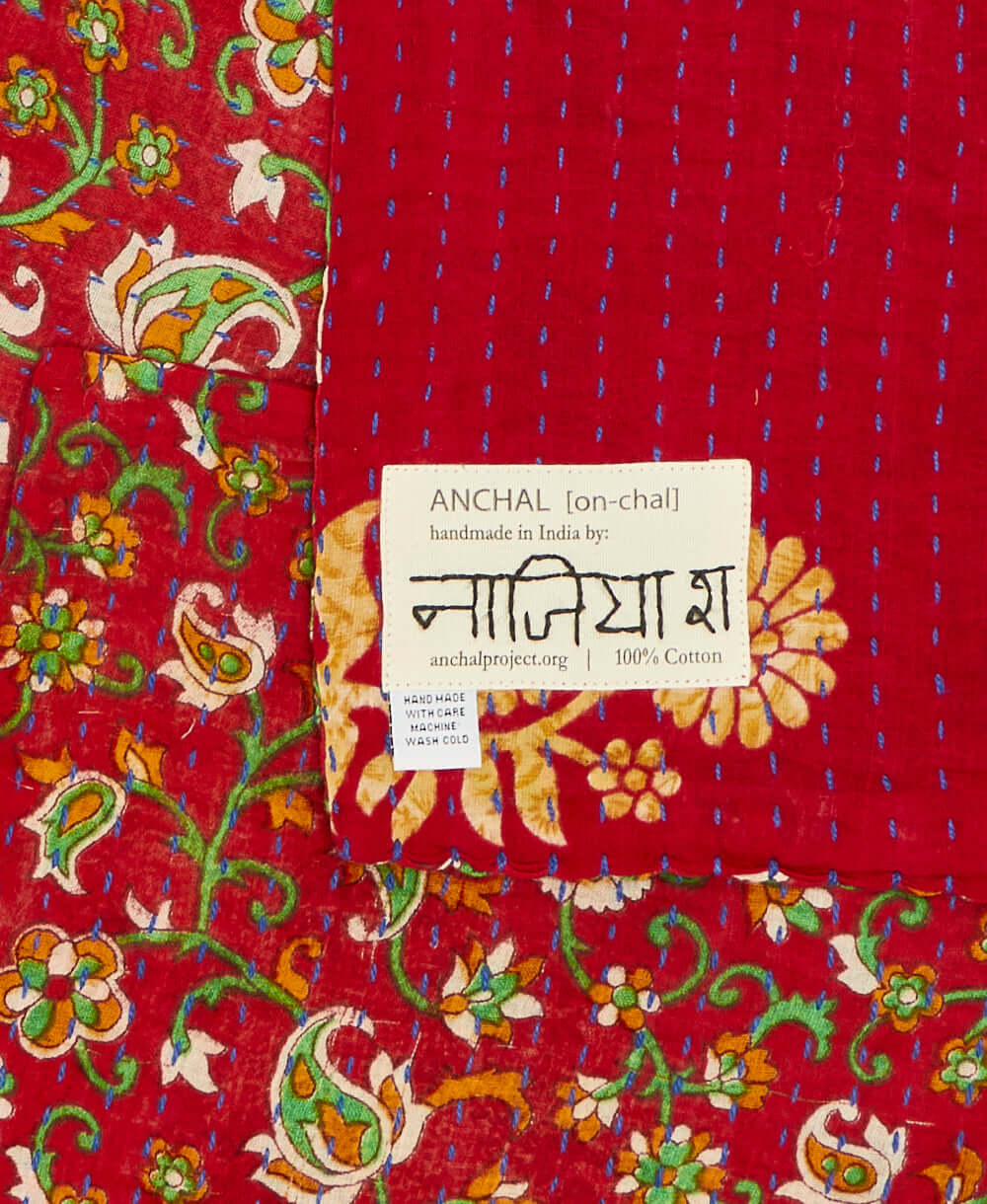 red floral small kantha quilt handmade in India and signed by the artisan maker on tag