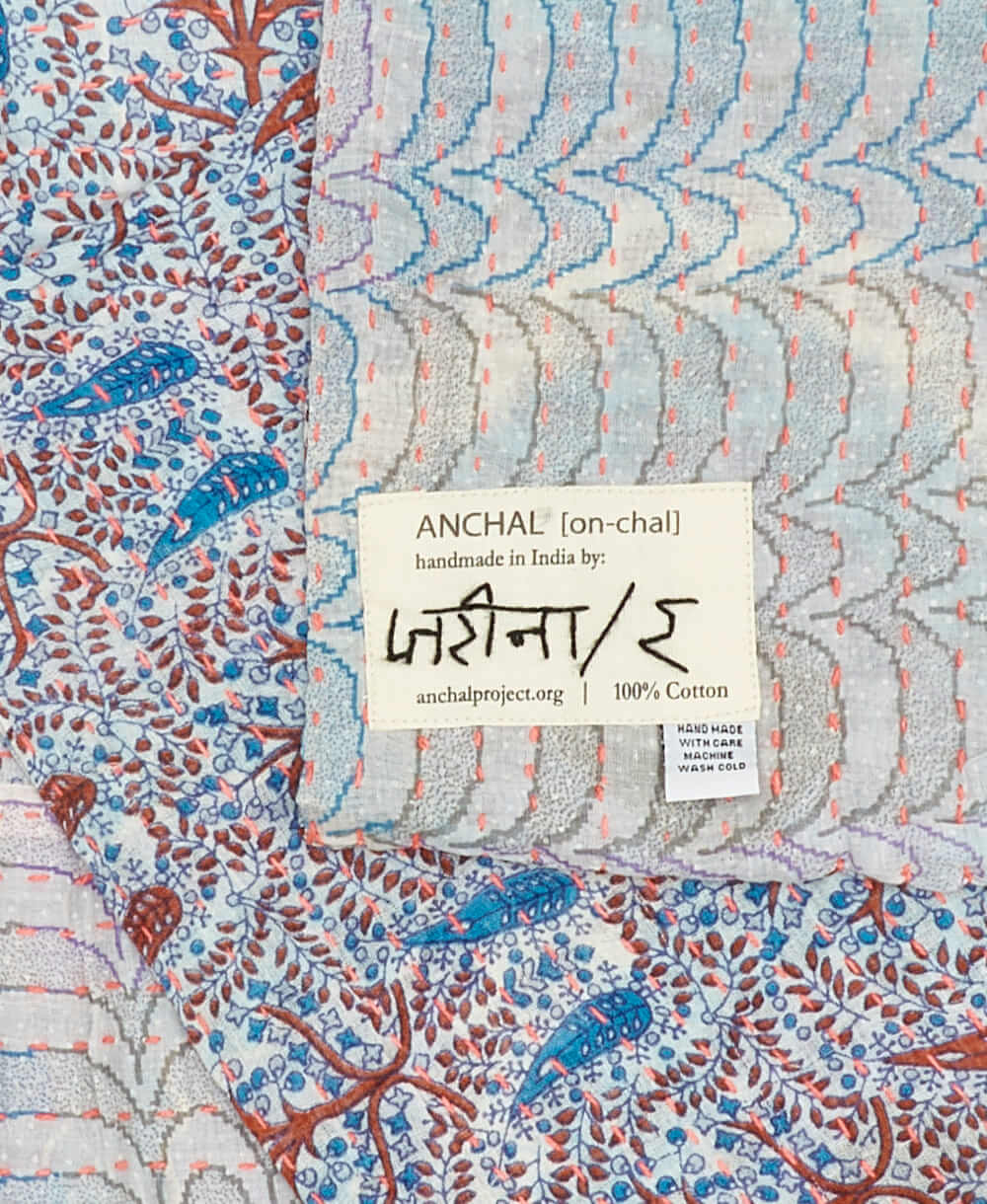 red and blue paisley small Kantha quilt throw featuring the hand-stitched
signature of the maker