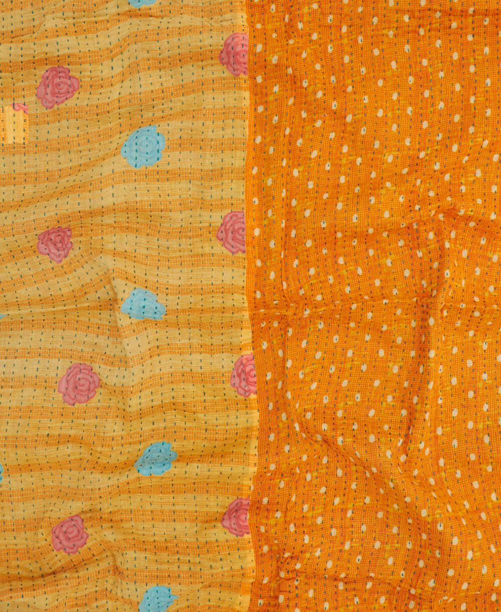 orange kantha blanket with pastel yellow polka dot print with blue kantha stitching