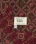 small kantha blanket in deep burgundy purple diamond print with signature of the maker on the tag