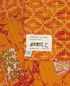 small kantha blanket in tangerine orange & tan diamond print with signature of the maker on the tag