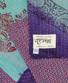 small kantha blanket in indigo purple & sky blue stripe print with signature of the maker on the tag