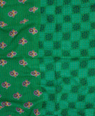 green kantha blanket with checkered floral print and yellow kantha stitching