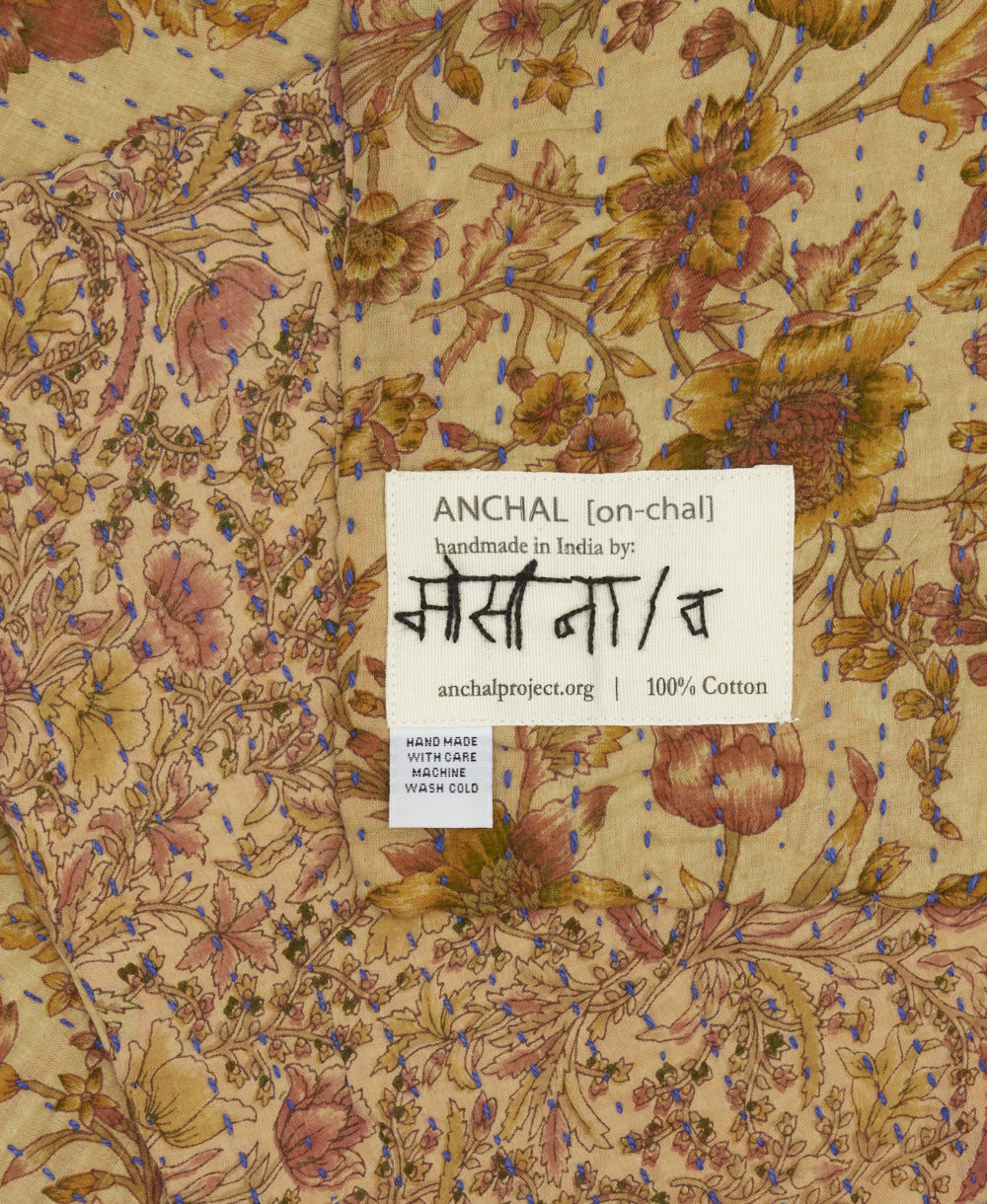 small kantha blanket with signature of the maker on the tag