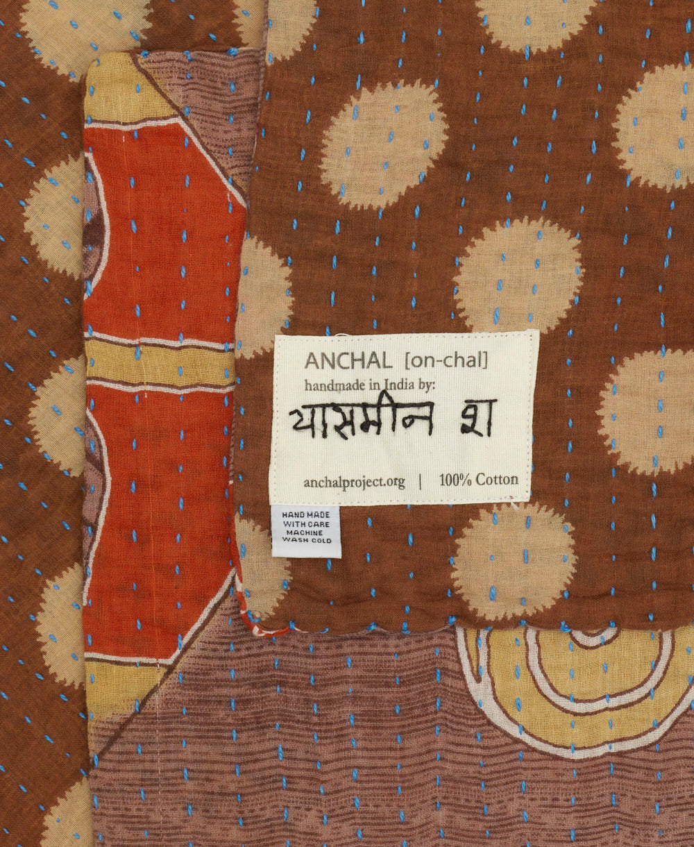 small kantha blanket with signature of the maker on the tag