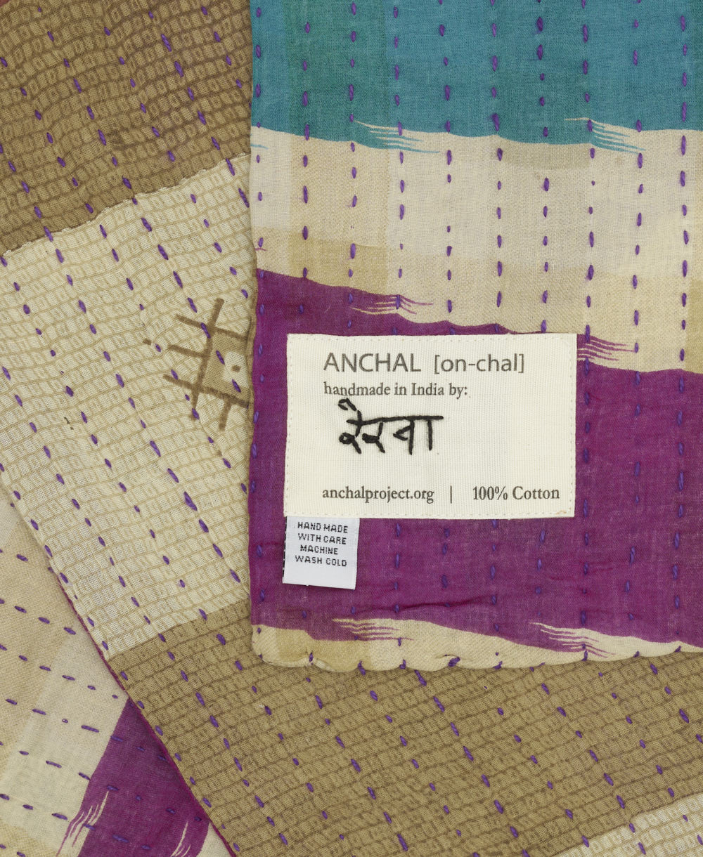 small kantha blanket with signature of the maker on the tag