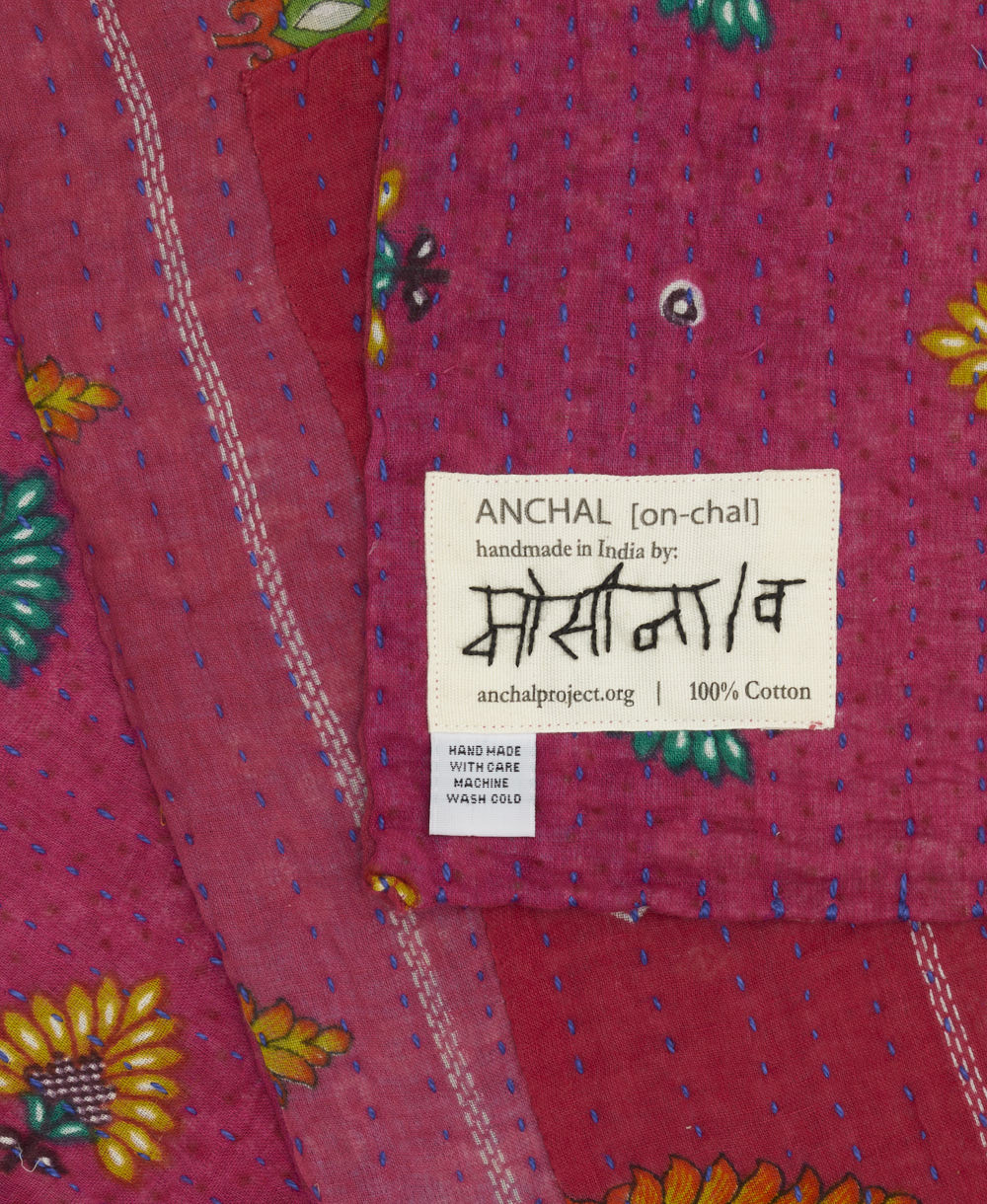 small kantha blanket with signature of the maker on the tag