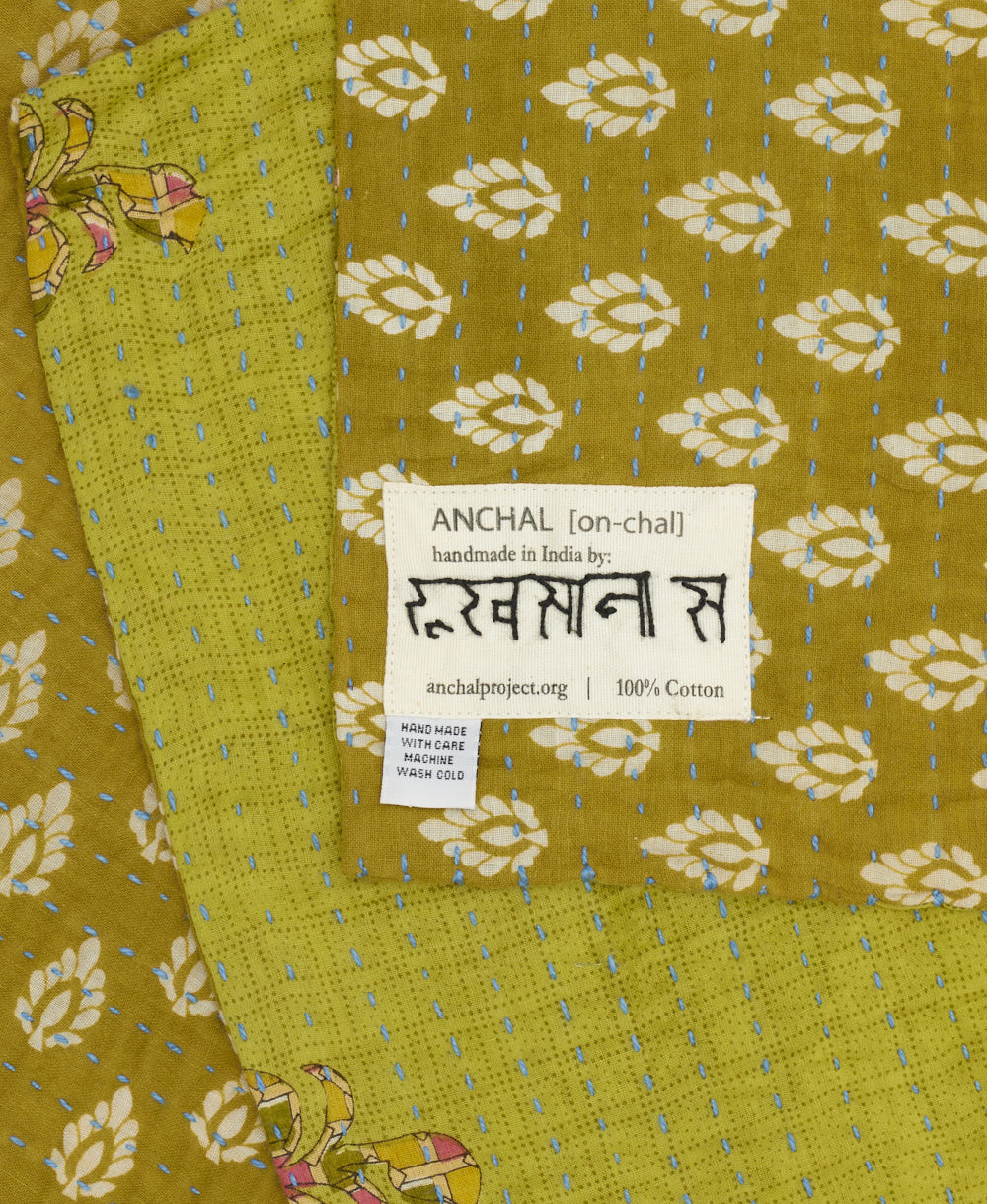 small kantha blanket with signature of the maker on the tag