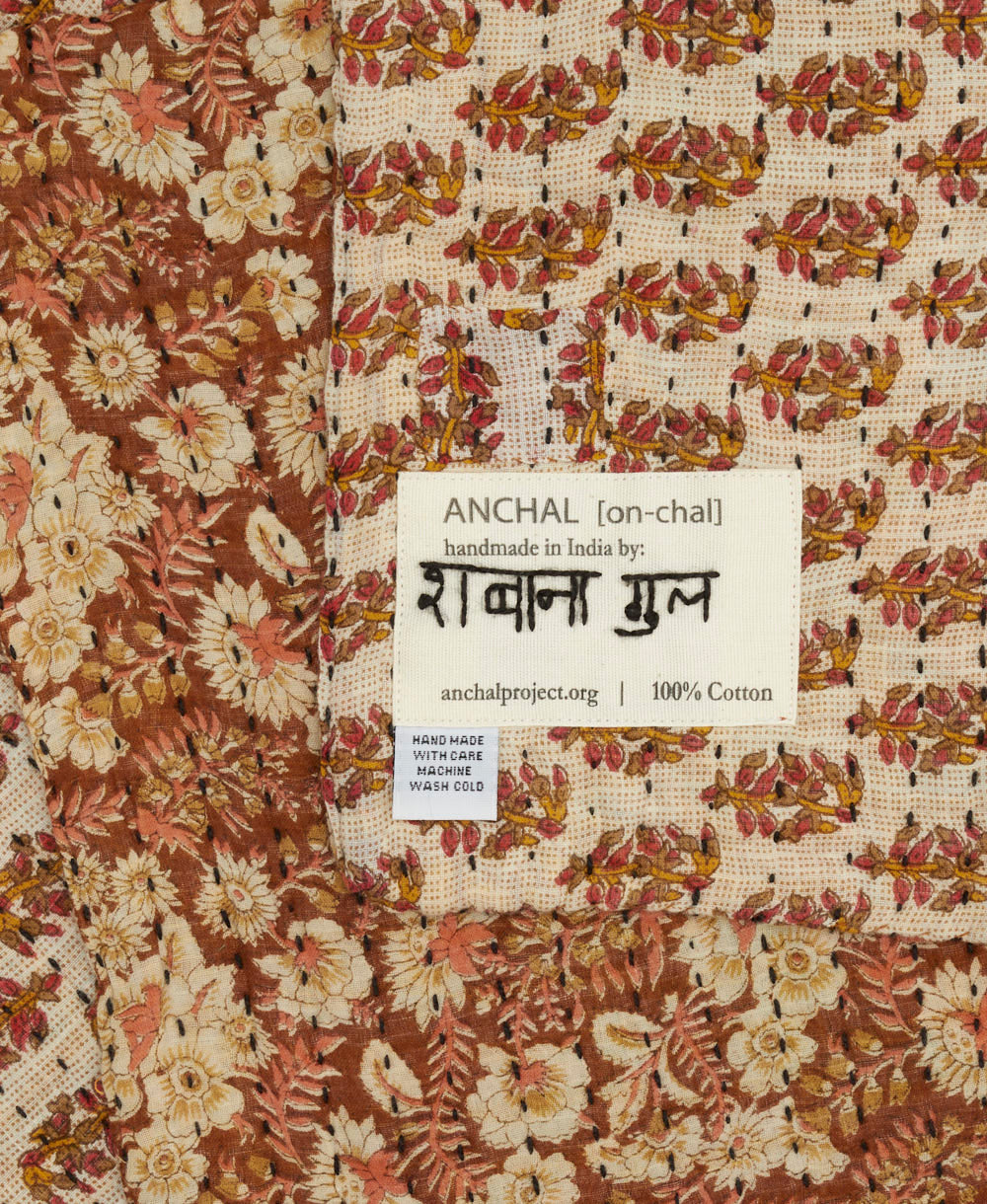 small kantha blanket with signature of the maker on the tag