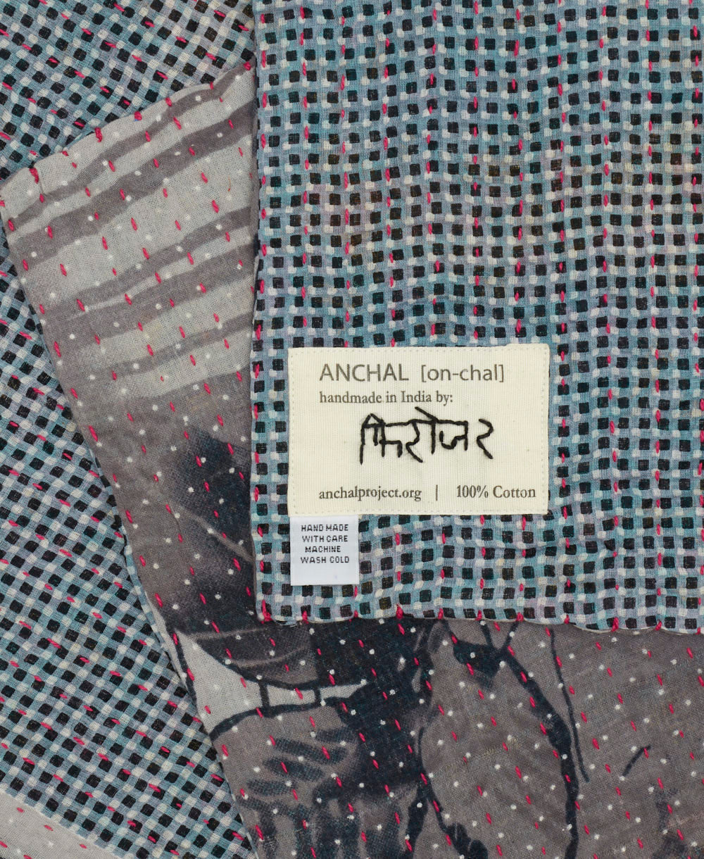 small kantha blanket with signature of the maker on the tag