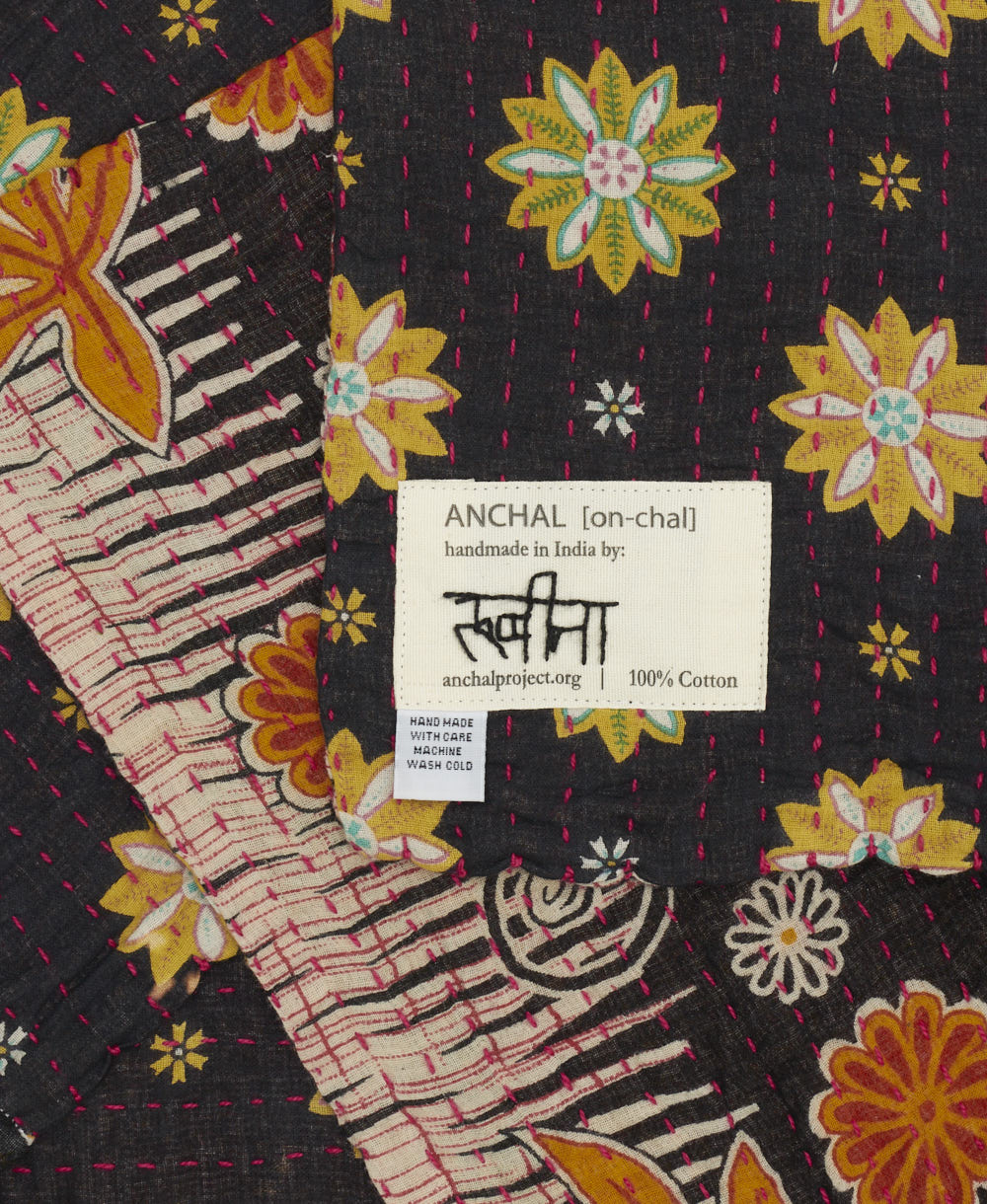 small kantha blanket with signature of the maker on the tag