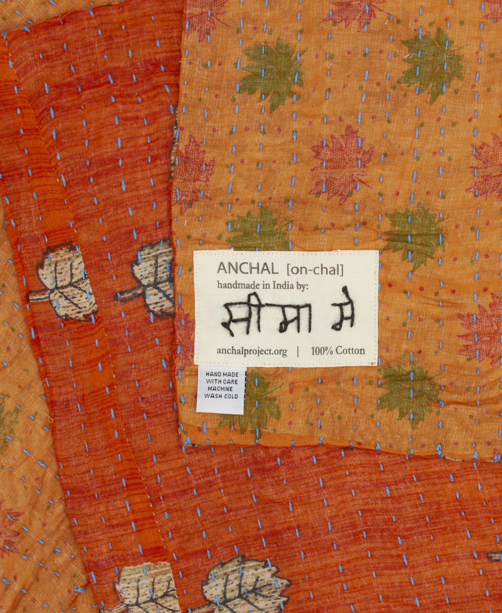 small kantha blanket with signature of the maker on the tag