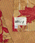 small kantha blanket with signature of the maker on the tag