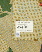 small kantha blanket with signature of the artisan maker on the tag