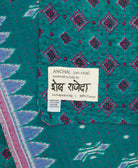small kantha blanket with signature of the artisan maker on the tag