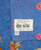 small kantha blanket with signature of the artisan maker on the tag