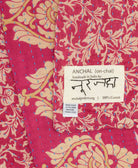 small kantha blanket with signature of the artisan maker on the tag