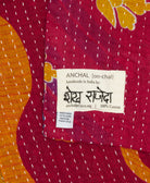 small kantha blanket with signature of the artisan maker on the tag