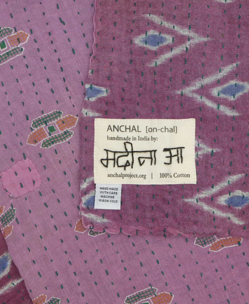 small kantha blanket with signature of the maker on the tag