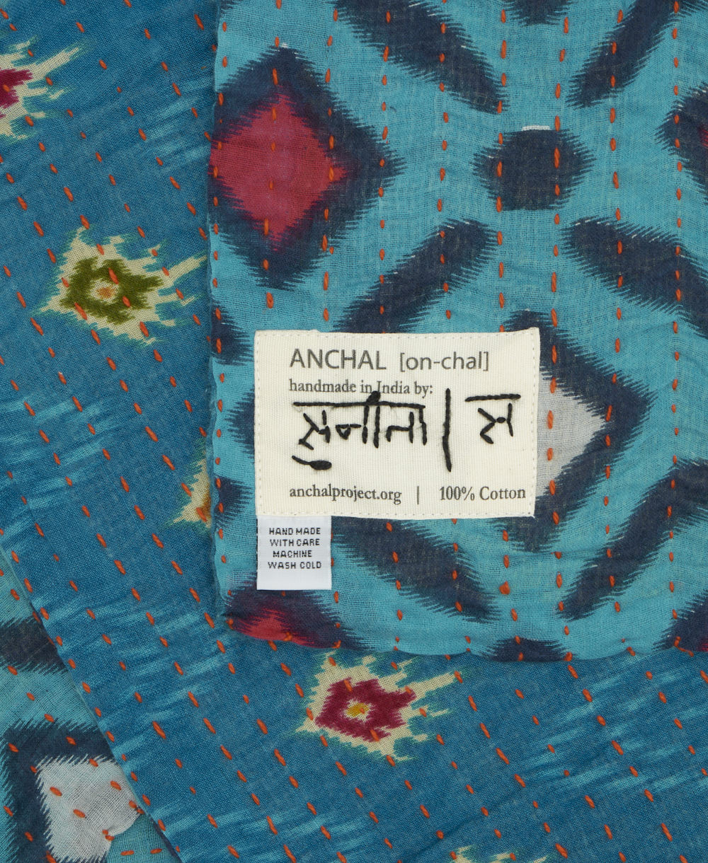 small kantha blanket with signature of the maker on the tag